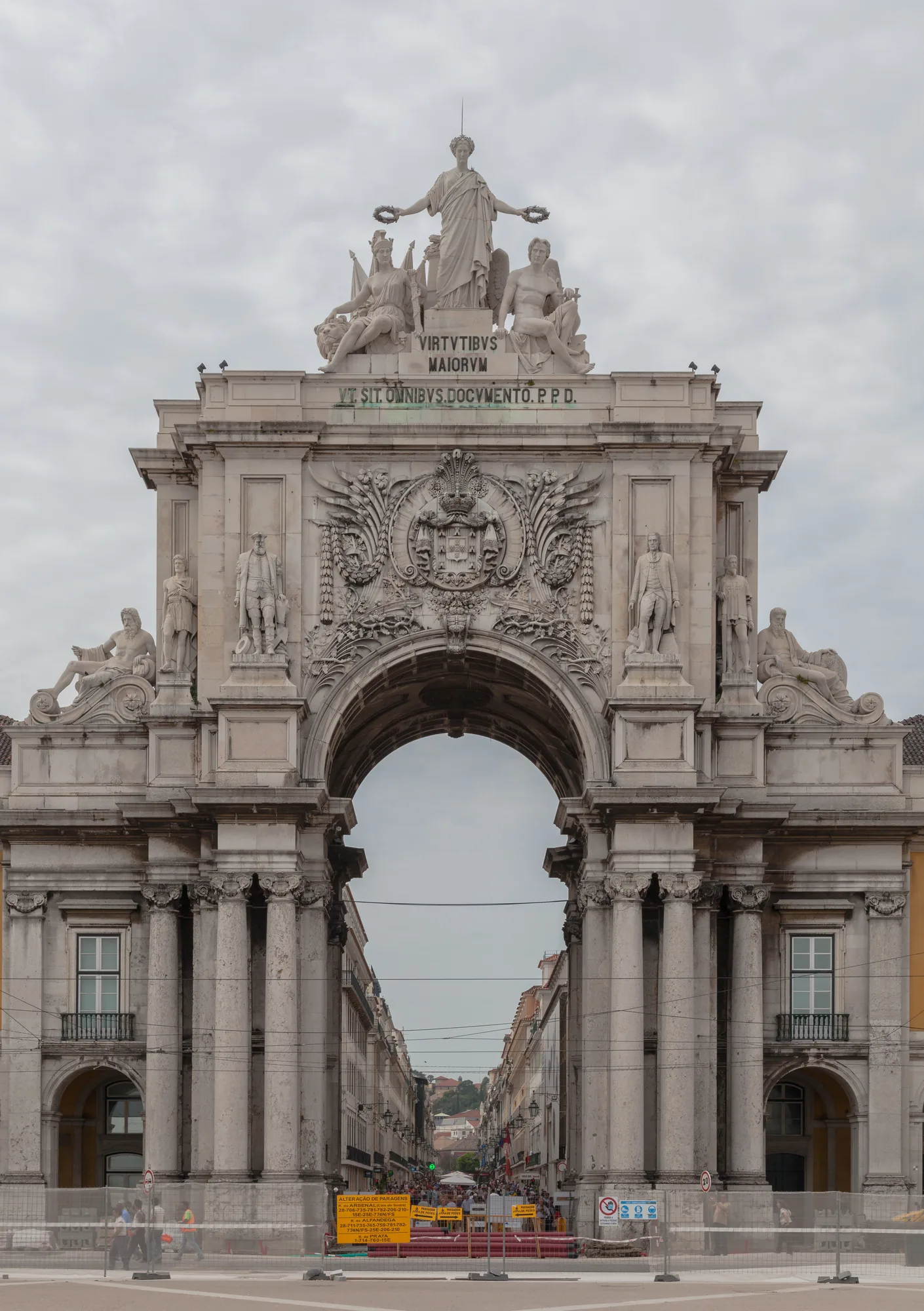 The Arco da Rua Augusta, a large white triumphal arch in Baixa, Lisbon, with allegorical statues crowning its top and Rua Augusta street visible through the central archway